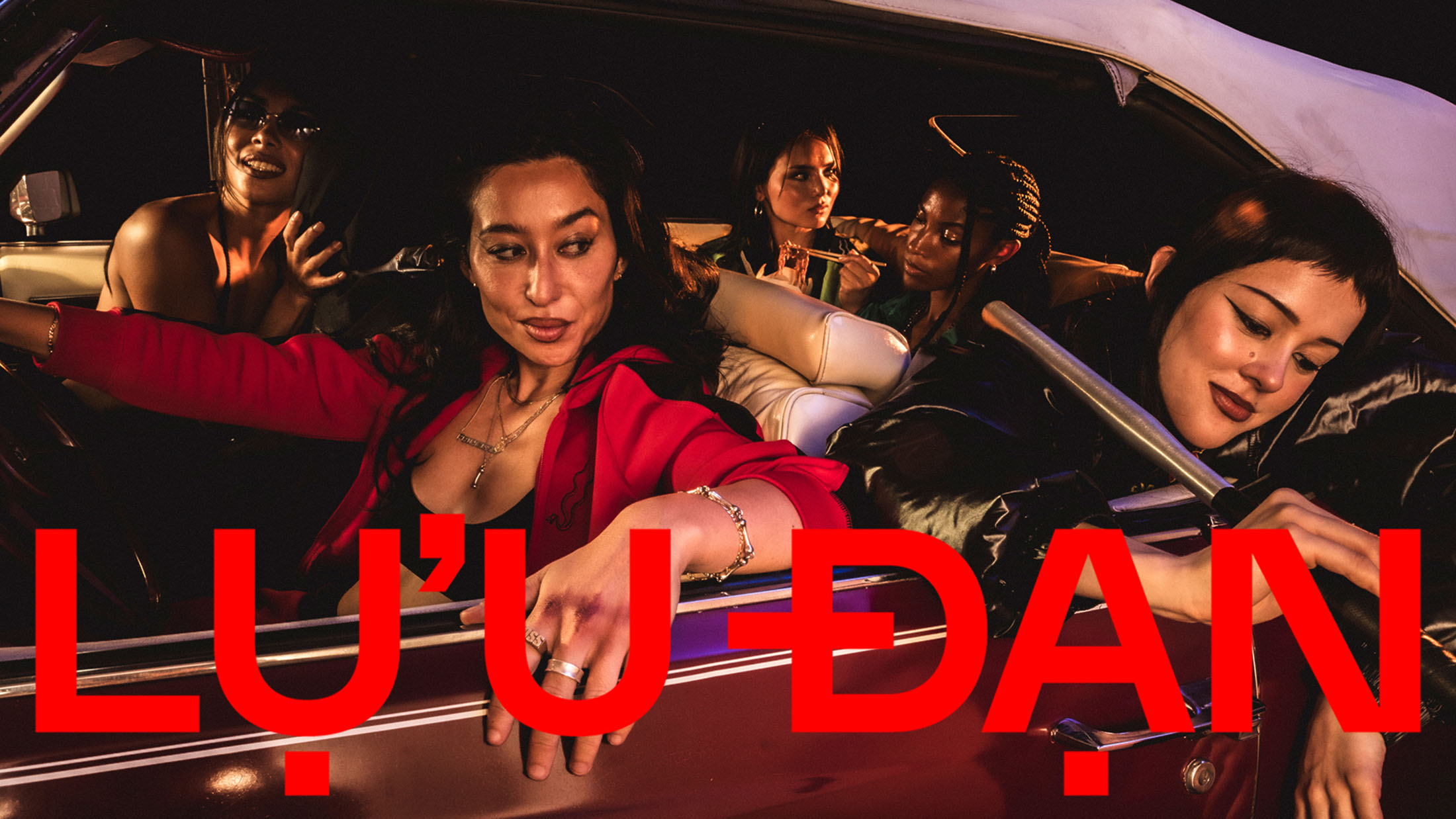Five models inside a vintage car at night for Lu'u Dan The Getaway Car campaign