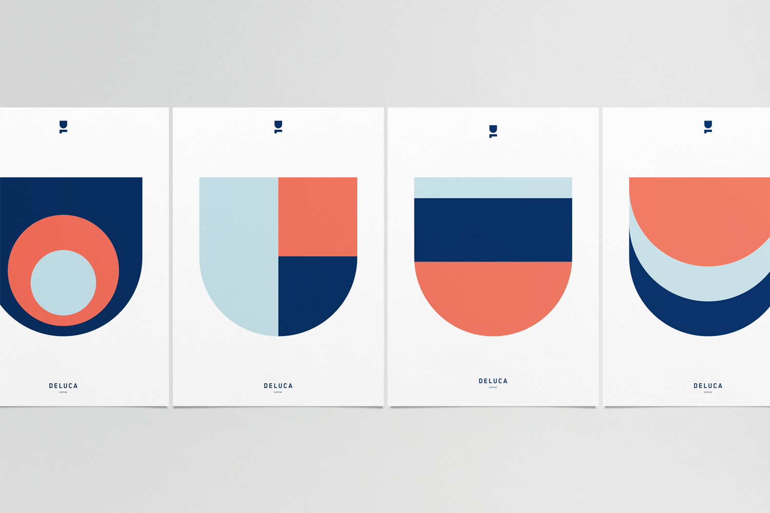 Four graphic design posters featuring geometric shapes in navy blue, coral red, and pale blue on a clean white background