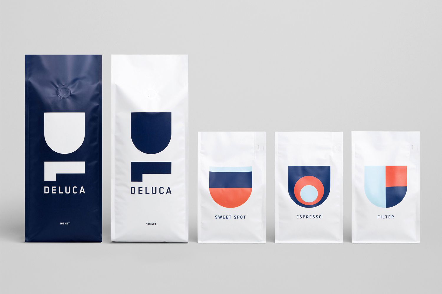 Five minimalist coffee packaging bags with bold blue, white, and red geometric typography against a light grey background.
