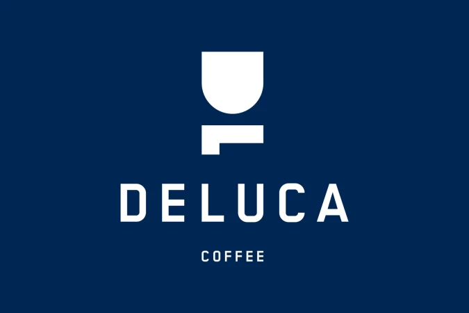 Deluca Coffee brand identity logo featuring white typography and graphic icon on a deep navy blue background