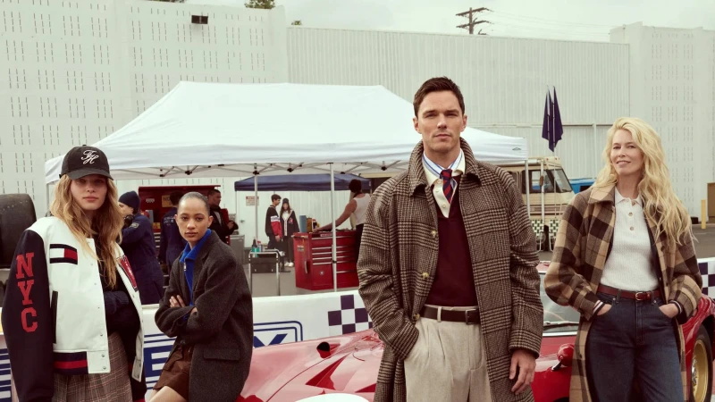Nicholas Hoult and Claudia Schiffer with models posing outdoors by a red car for Tommy Hilfiger Fall 2025 ad campaign.