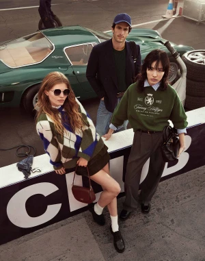 Three models posing outdoors near a classic green sports car for Tommy Hilfiger Fall 2025 ad campaign.