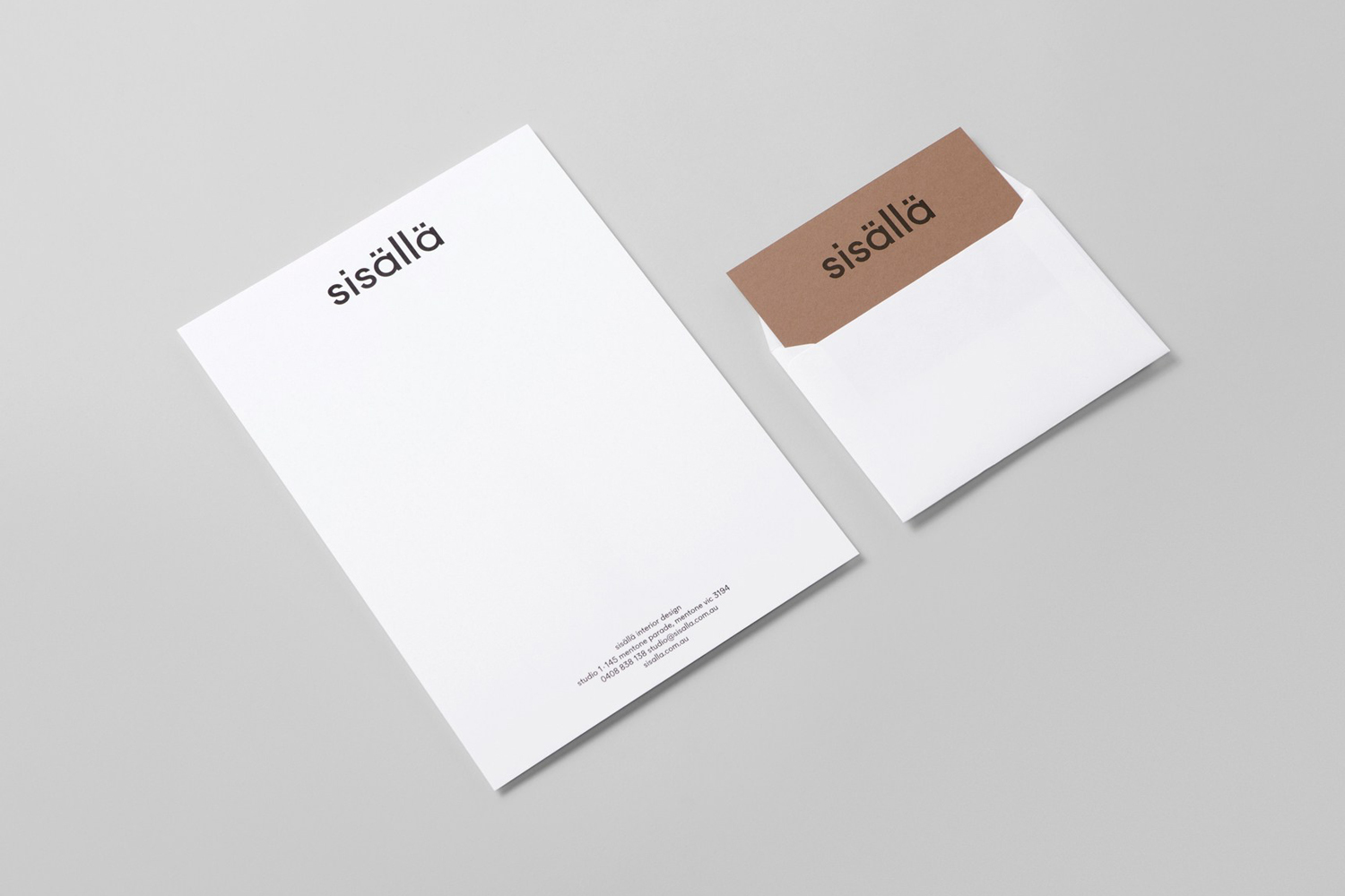 Branding mockup featuring a white letterhead and envelope with brown flap displaying the sisällä logo on a grey background