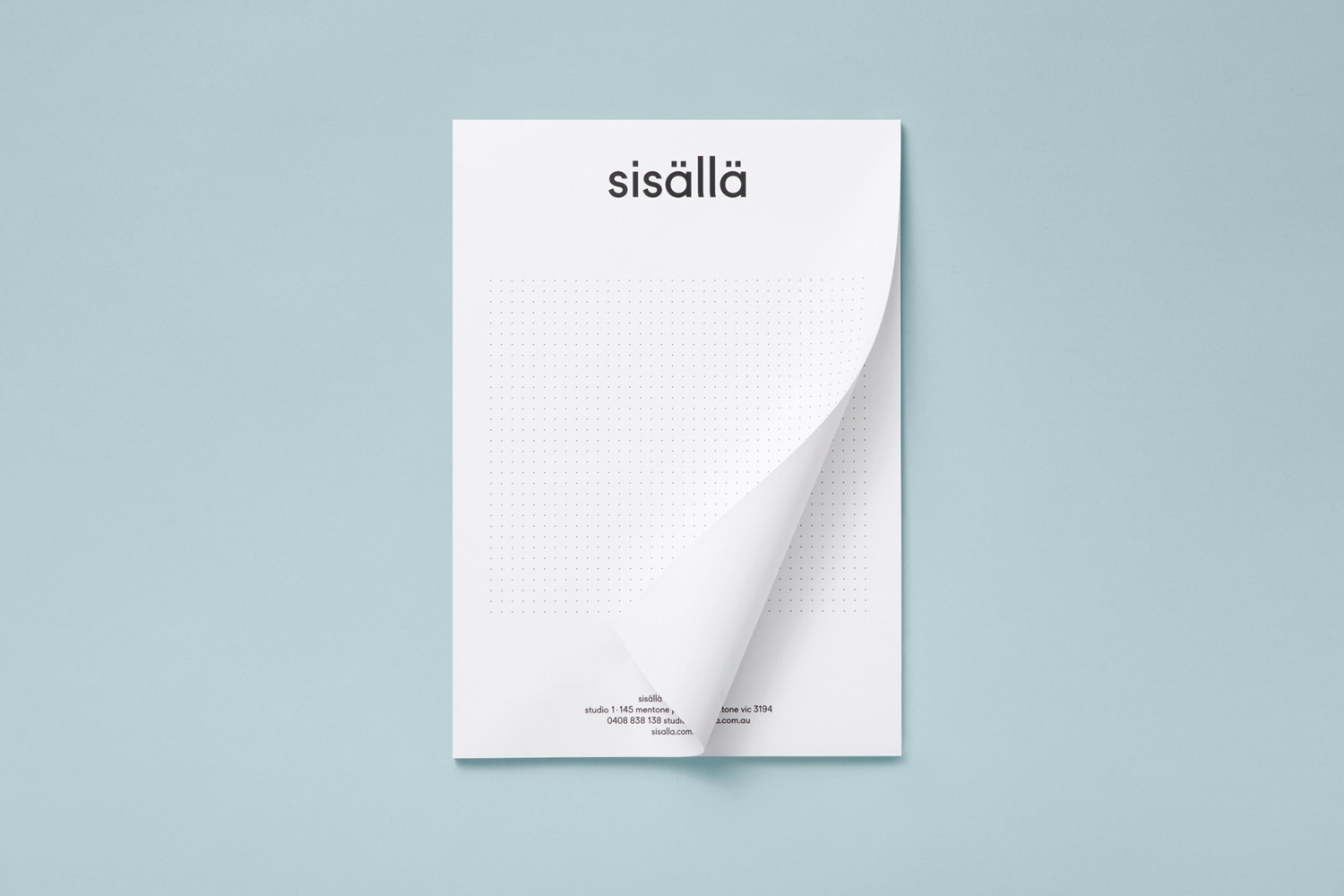 Letterhead stationery mockup with a curved corner resting against a pale blue background