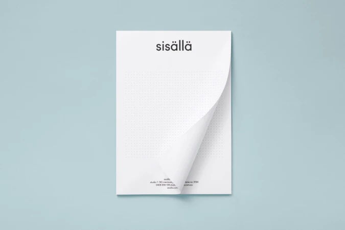 Letterhead stationery mockup with a curved corner resting against a pale blue background