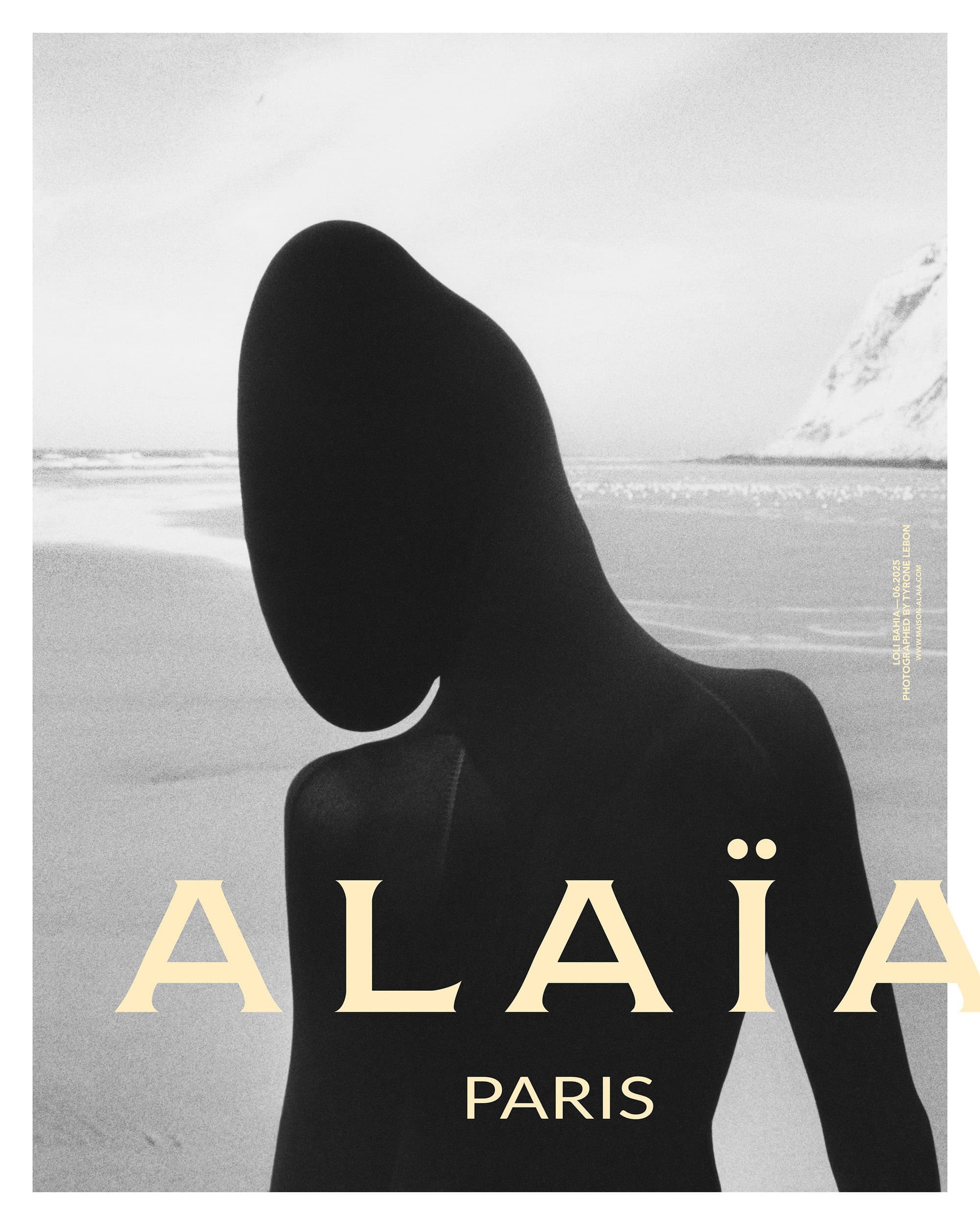 Model silhouetted against a sandy coastal landscape for an Alaïa fashion campaign photograph