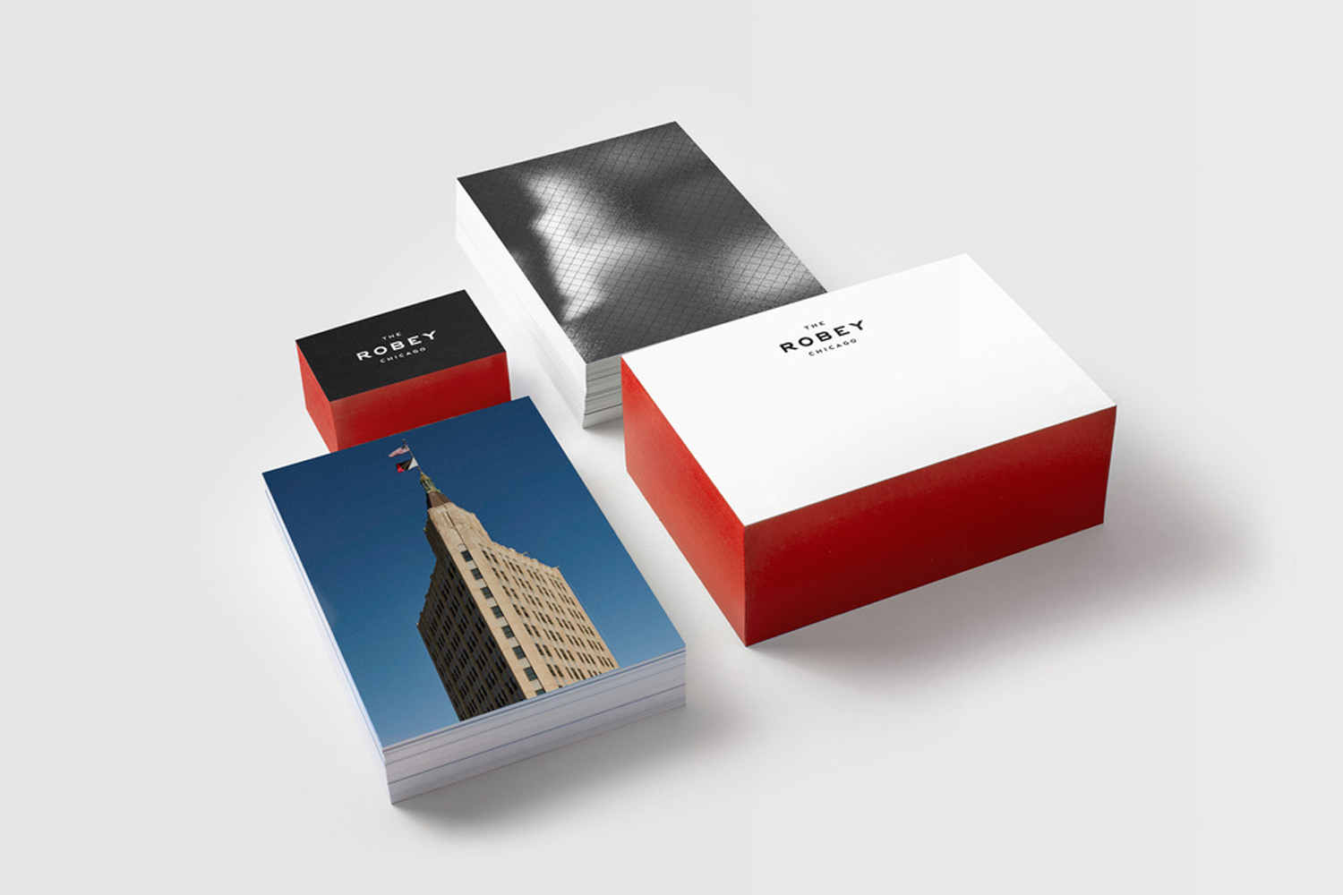 The Robey brand identity stationery featuring stacked boxes, business cards, and printed cards on a white seamless background