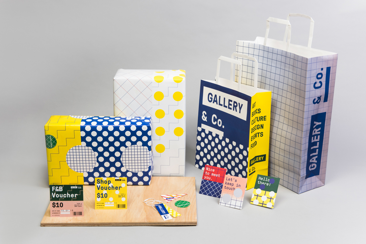 Branded packaging, paper bags, boxes, and vouchers featuring colorful geometric patterns and Gallery and Co typography