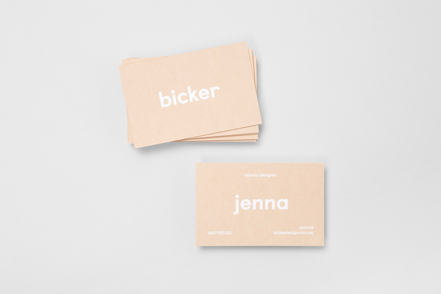 Stacked and laid out beige business cards featuring white typography for Bicker on a light grey background