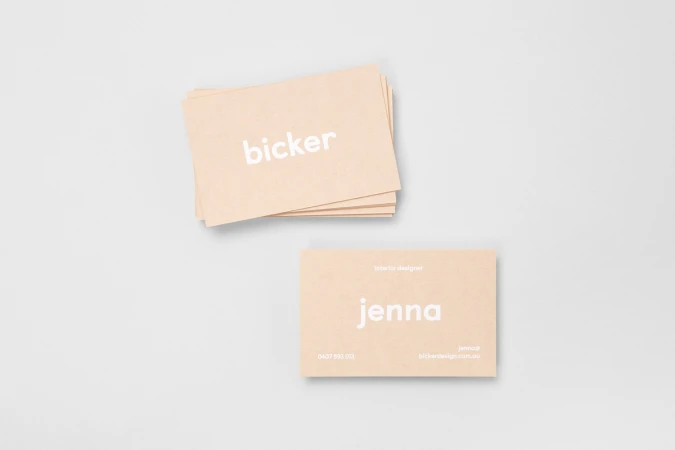 Stacked and laid out beige business cards featuring white typography for Bicker on a light grey background