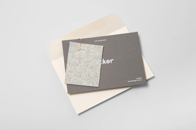 Branding materials for Bicker including a grey envelope card with gold paperclip and felt swatch on a white background
