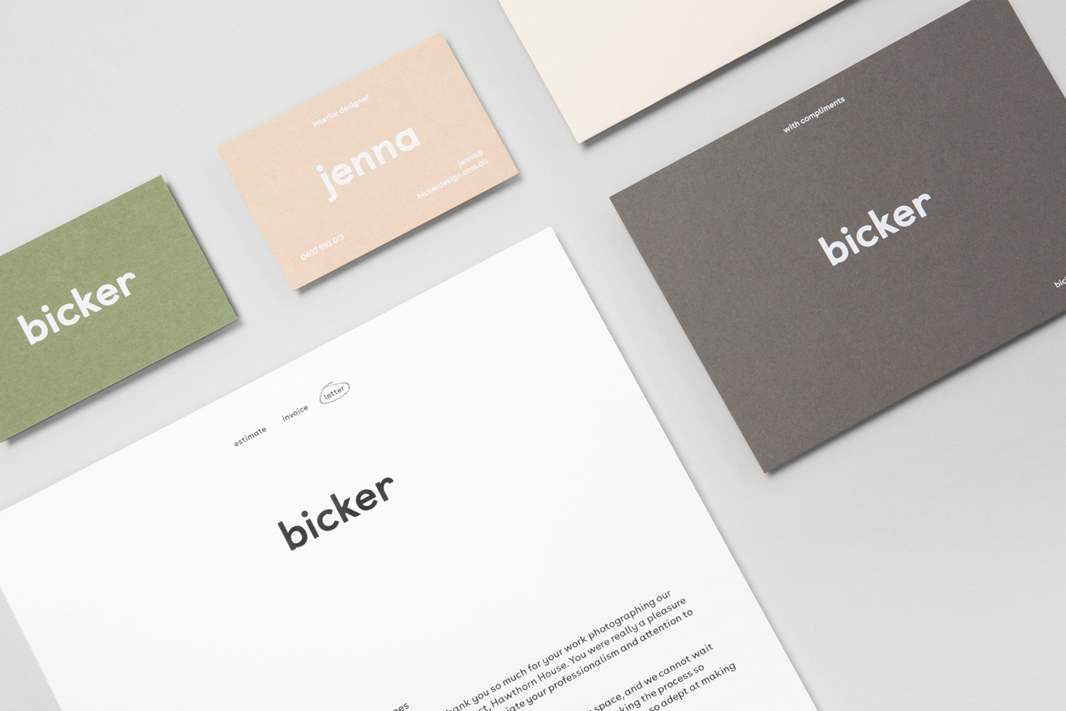 Flat lay of Bicker brand identity stationery including business cards and letterhead on a light grey surface.