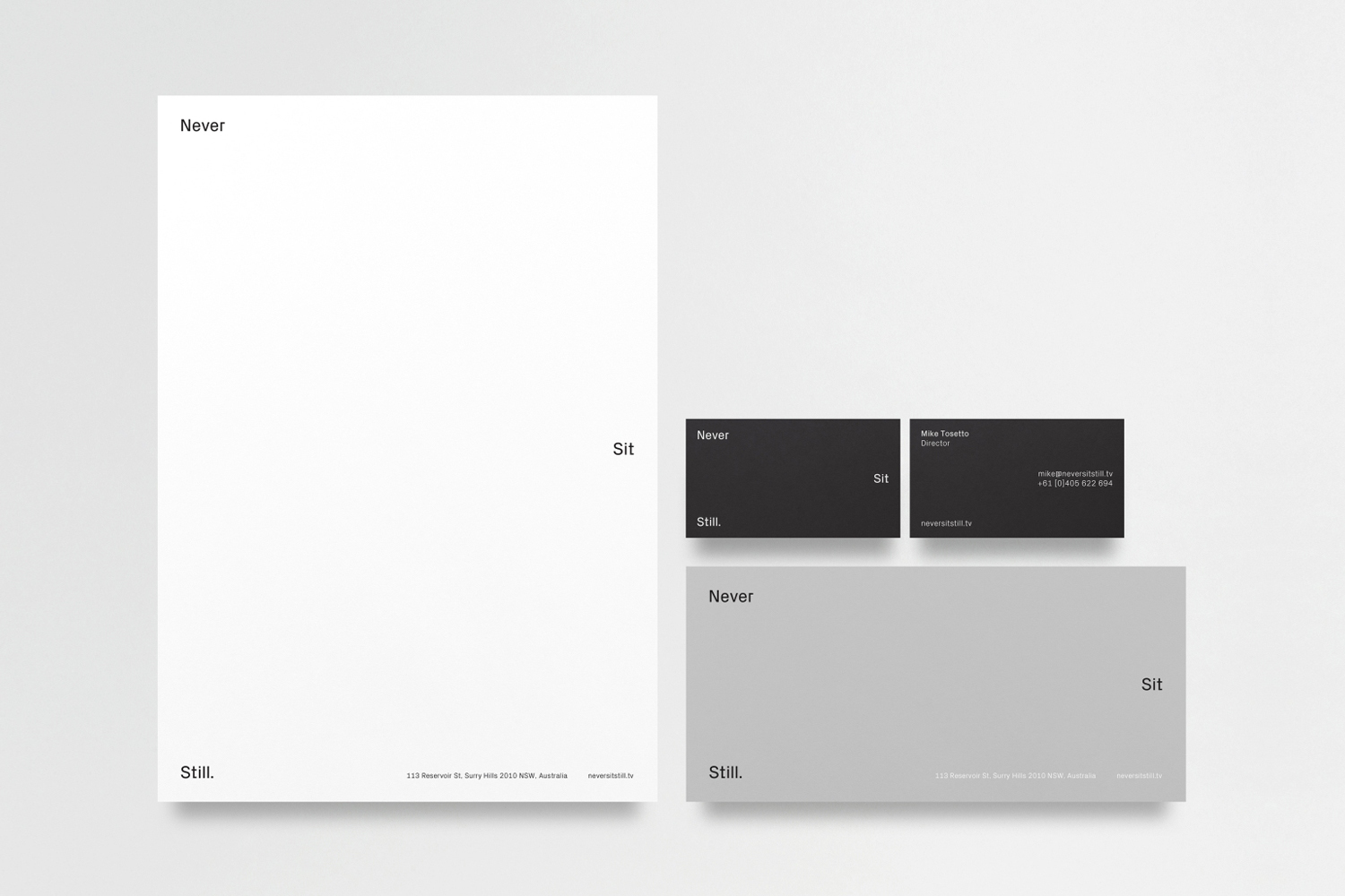 Minimalist stationery set including letterhead, business cards, and envelope featuring clean typographic layout on neutral backgrounds.
