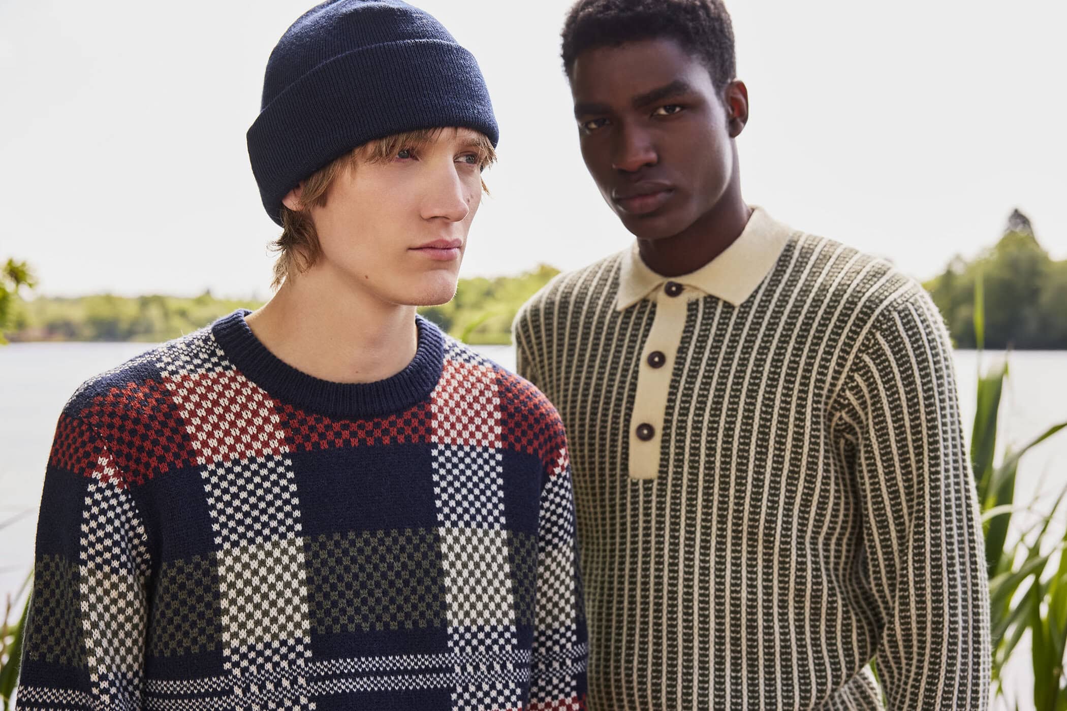 Two male models in patterned knitwear posing outdoors near a body of water for Ben Sherman campaign