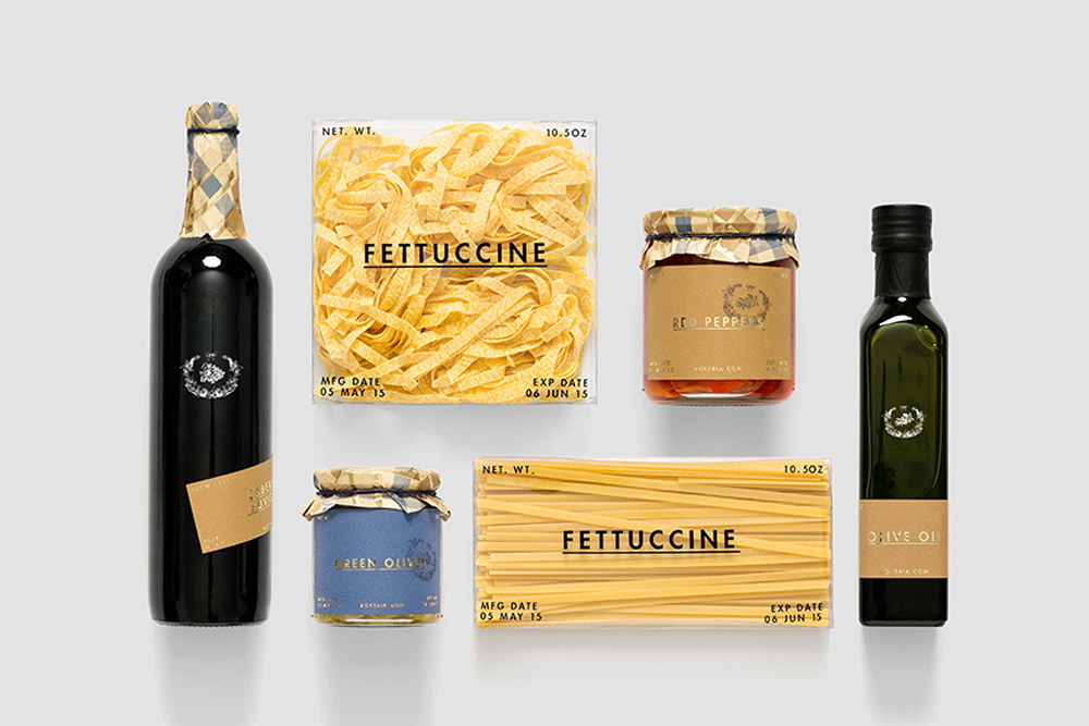 Top-down view of Bokeria brand food packaging including wine bottle pasta jars and olive oil on a white background