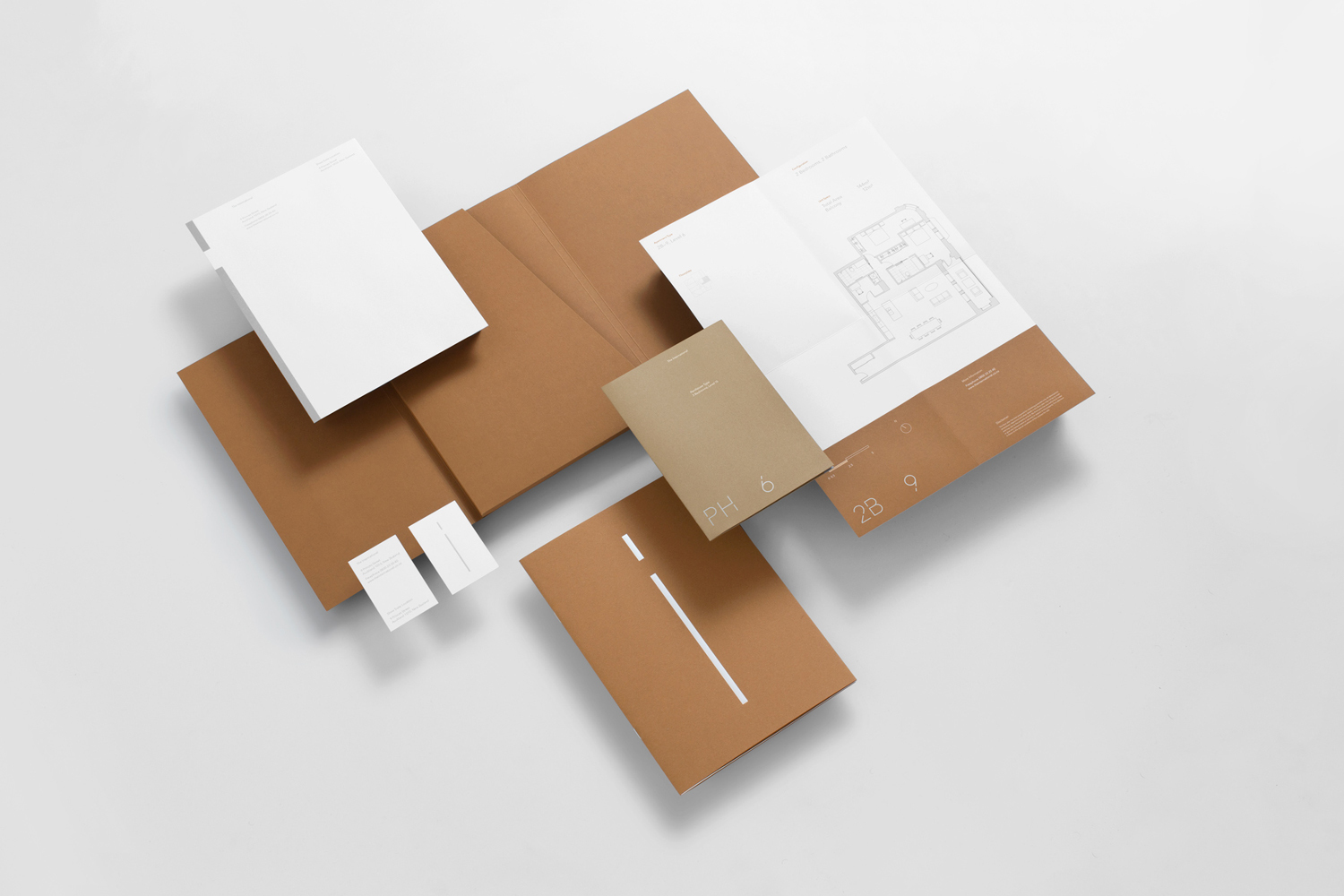 Flat lay of corporate stationery, including tan folders, white letterhead sheets, and business cards on a white background