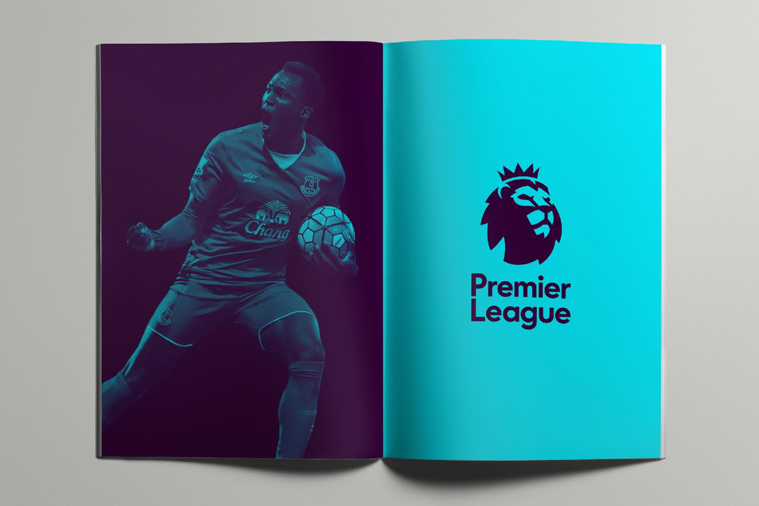 Open magazine displaying a soccer player celebrating on the left and the Premier League logo on the right page.