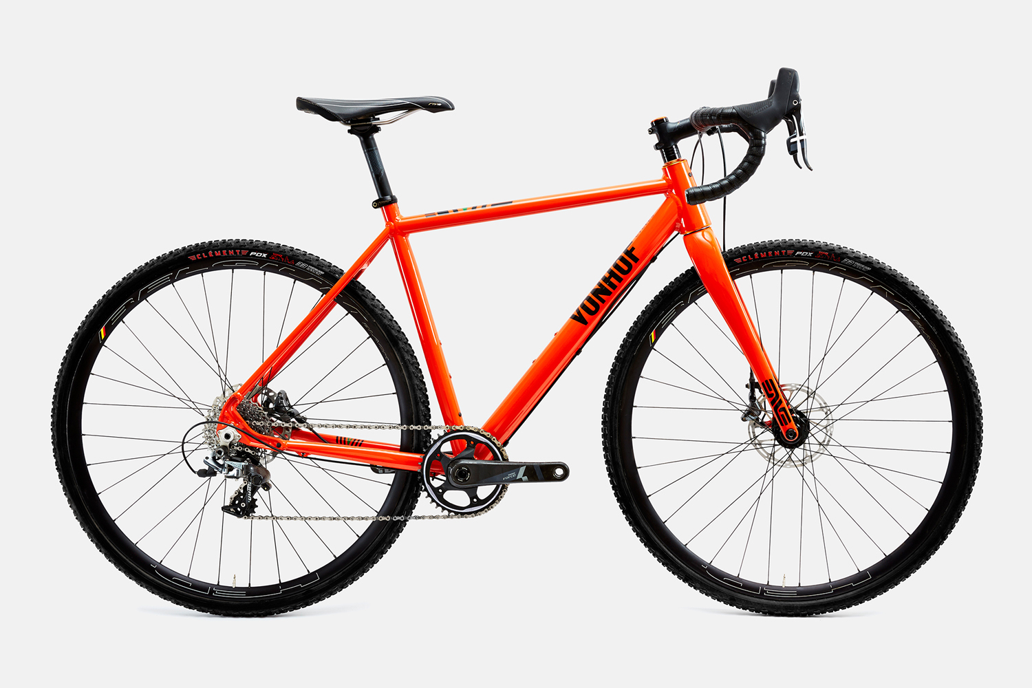 Bright orange road bicycle with drop handlebars and black tires against a clean white background.