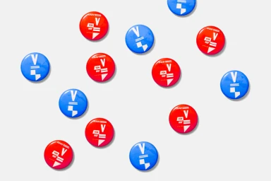 A collection of red and blue circular badges with white graphic designs arranged flat on a light grey background.