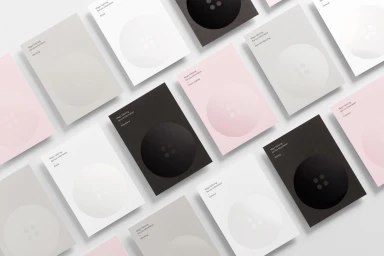 Grid of minimal stationery cards featuring large button graphics in pink white grey and black for Megs Tailoring