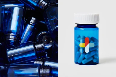 Split view of cobalt blue medicine bottles and a single blue pill bottle with a white cap and cross logo on white