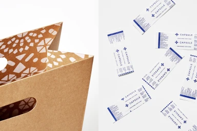 Close-up of a brown kraft paper bag with patterned interior alongside branded Capsule packaging strips on a white surface.