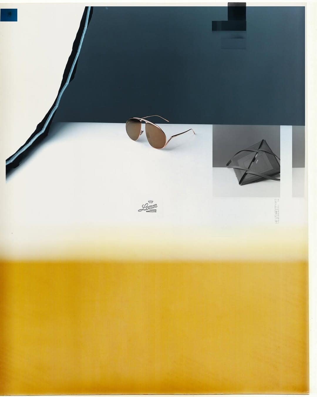 Loewe sunglasses and a small pouch on a multi-toned graphic surface with a yellow lower section