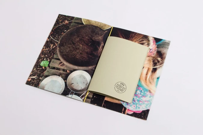 Open brochure for Forest Found displaying interior photography and a sage green insert against a white background