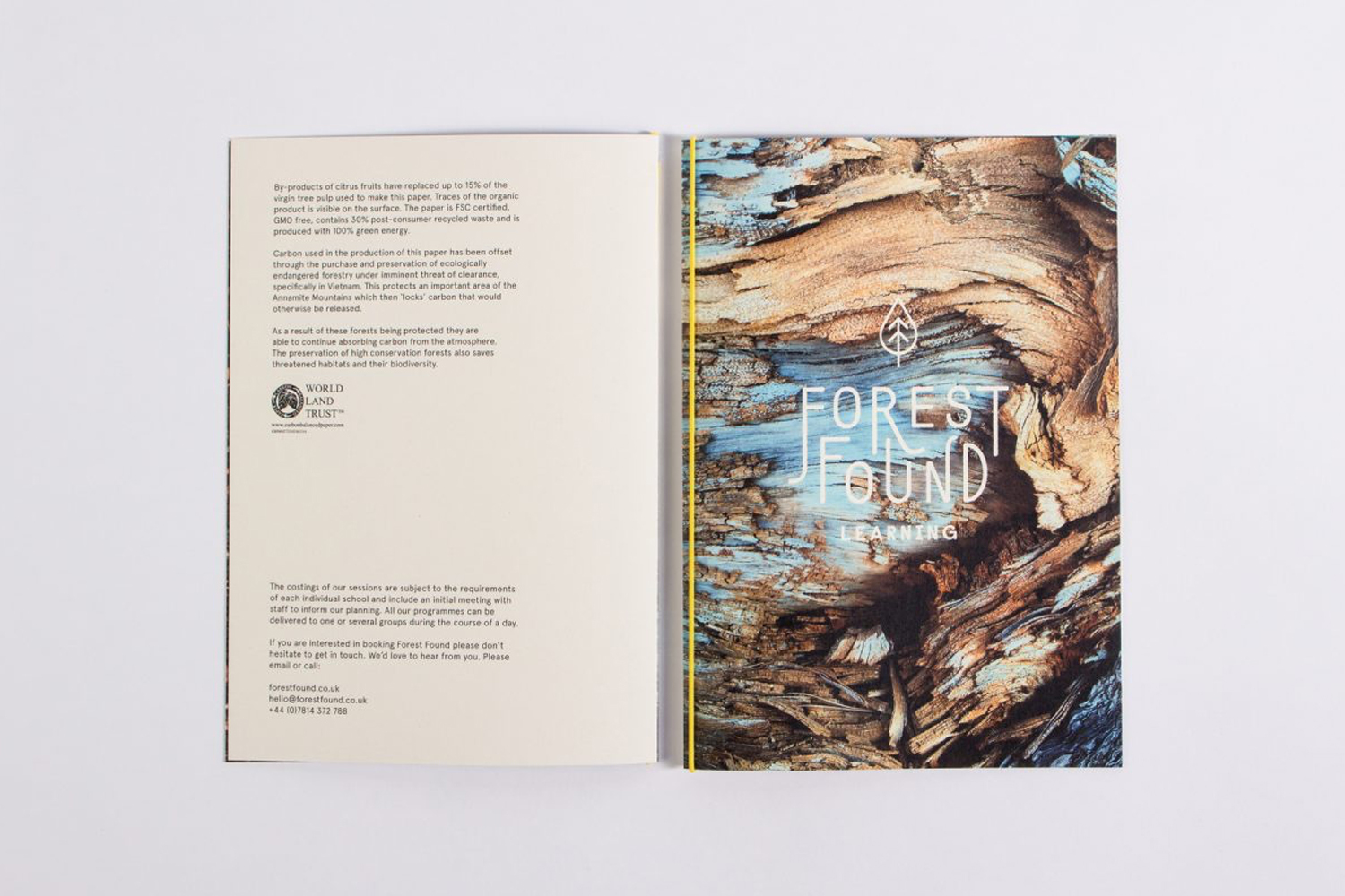 Open brochure for Forest Found with text page on left and detailed tree bark graphic on right against white background