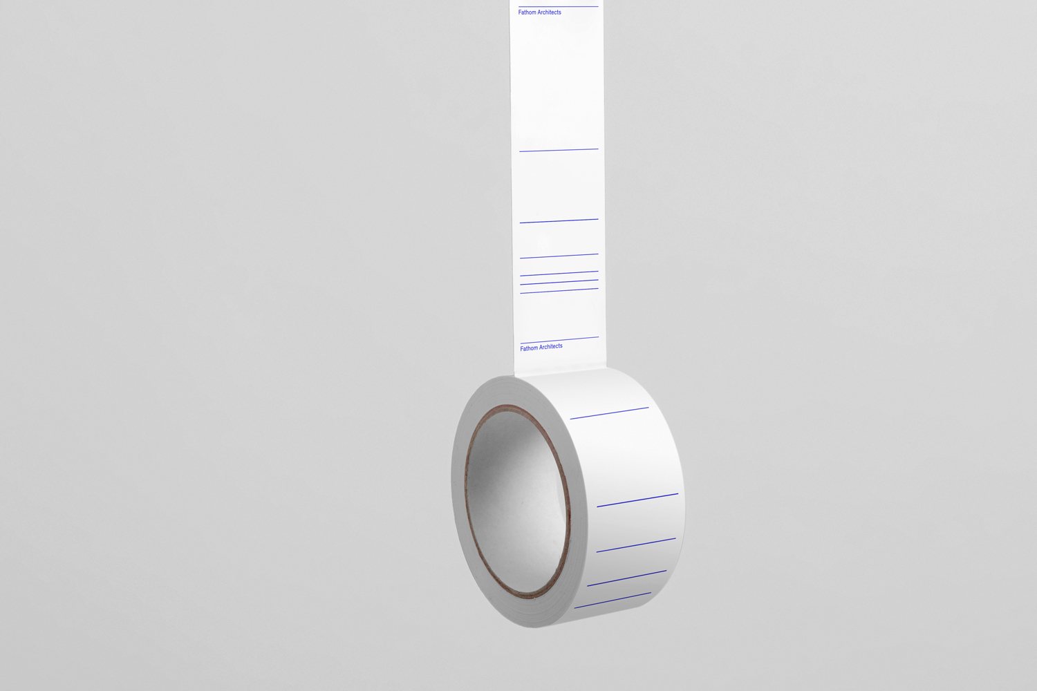 A roll of white adhesive labels with blue printed lines suspended against a pale grey background for Fathom Architects brand identity