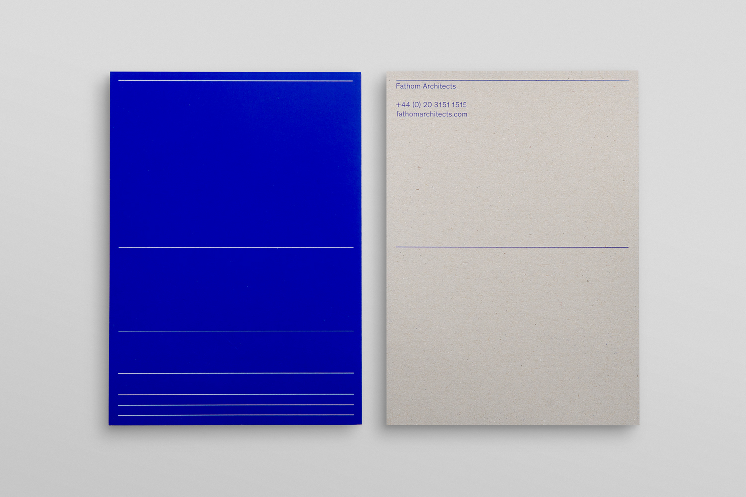Two rectangular stationery cards displayed side by side on a light surface, featuring blue and off-white designs.