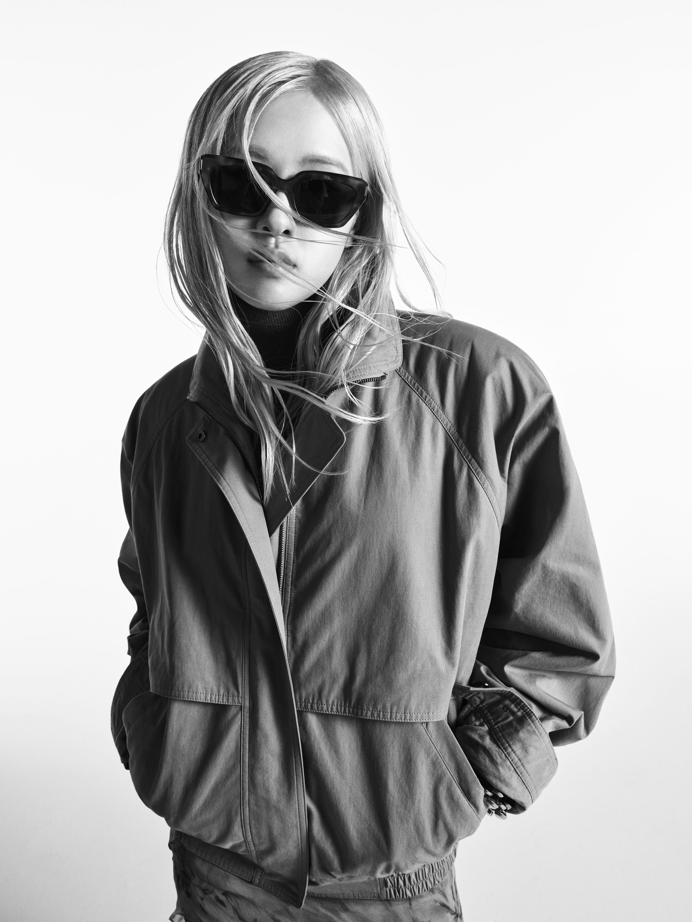 Rose wearing dark sunglasses and a jacket against a white background for Saint Laurent Fall 2025 campaign photographed by Gray Sorrenti.