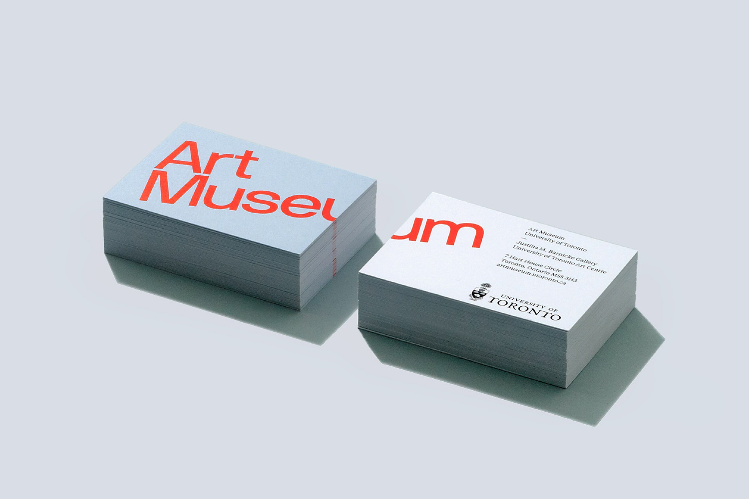 Two stacks of business cards with red typography on a light grey background, designed by Underline Studio for Art Museum University of Toronto.