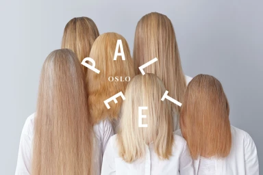 Group of six blonde people facing away from camera wearing white shirts against a grey background with white typography