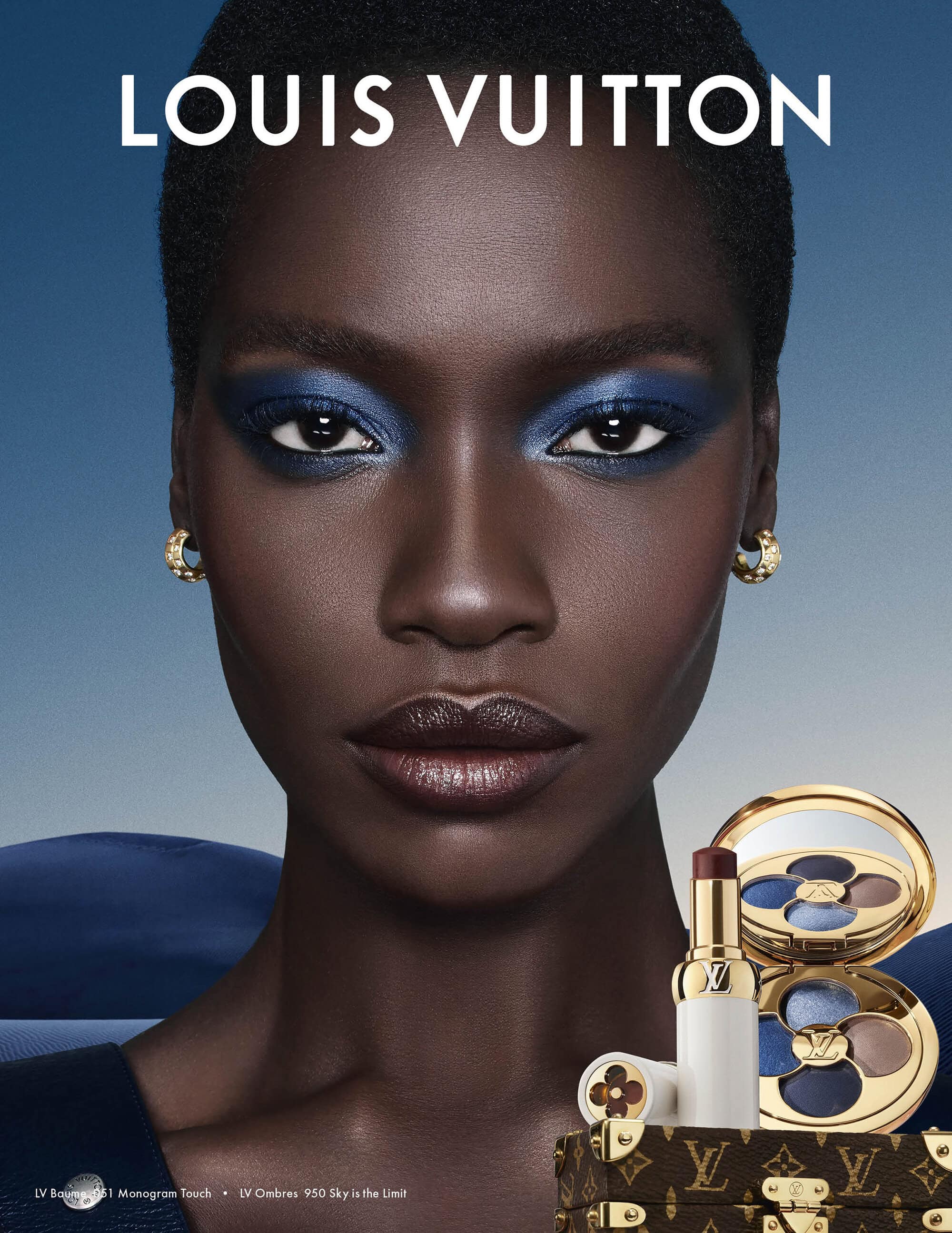 Close-up portrait of a Black woman with bold blue eyeshadow and lipstick against a gradient background featuring Louis Vuitton makeup products.