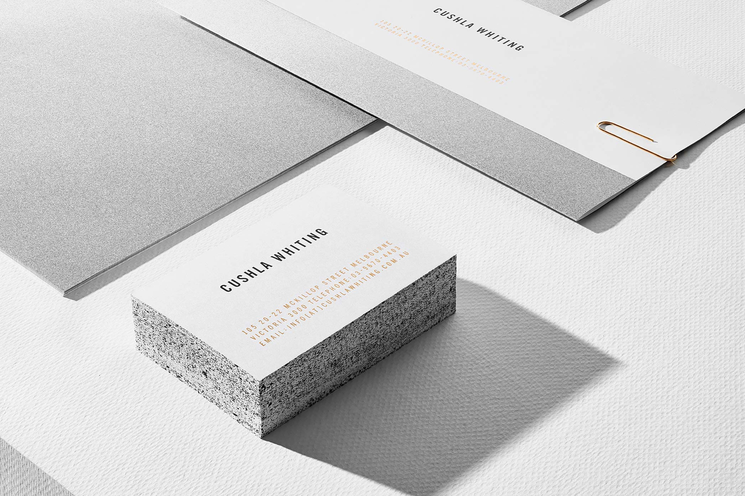 Cushla Whiting brand identity featuring business cards and stationery on textured white paper with a paperclip