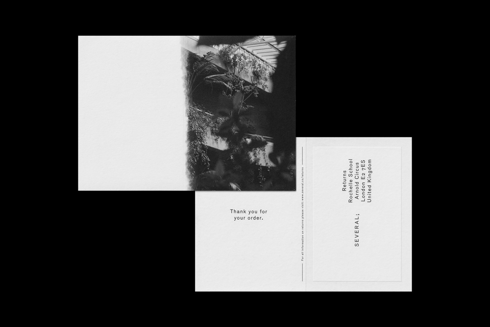 Two black and white postcards featuring minimalist typography and a photographic print of a botanical courtyard against a black ground.