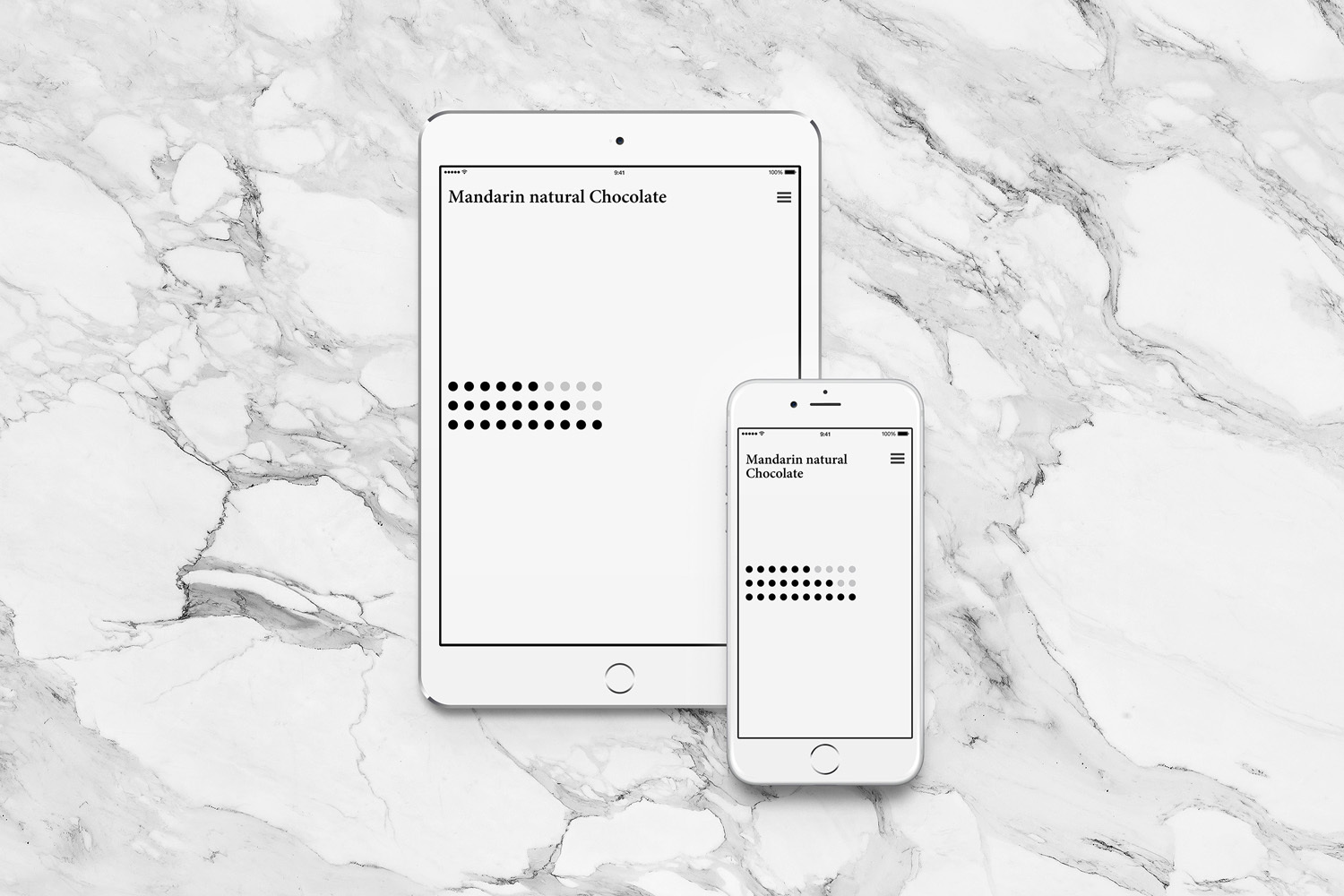 White tablet and smartphone displaying Mandarin natural Chocolate website against marble