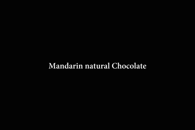 White typography reading Mandarin natural Chocolate centered against a solid black background.