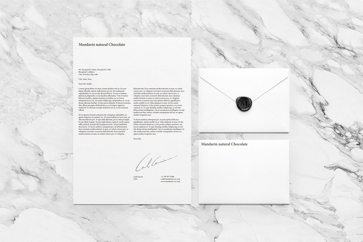 Branding mockup featuring a letterhead and two envelopes with a wax seal resting on a marble surface.