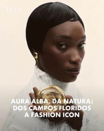 Close-up of a Black woman with short hair and gold earrings, holding a perfume bottle, fashion and beauty advertising.