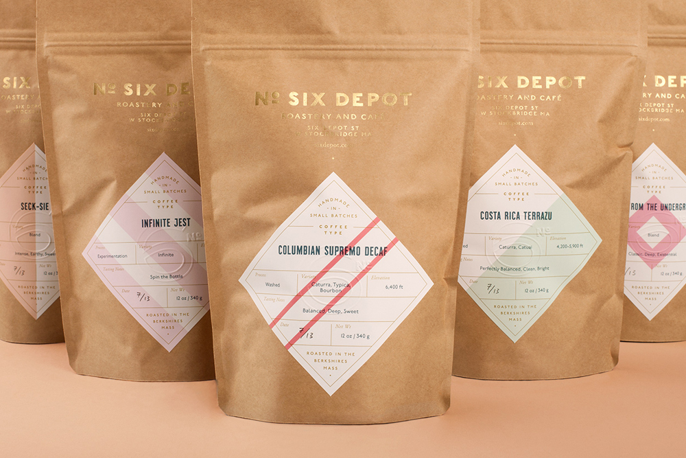 Close-up of five brown paper coffee bags with custom diamond labels for No. Six Depot brand identity project.