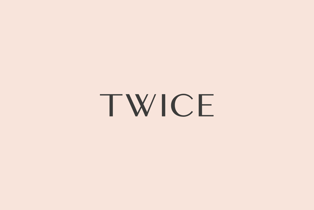 Twice brand identity typography featuring dark grey serif letters centered against a pale peach background.
