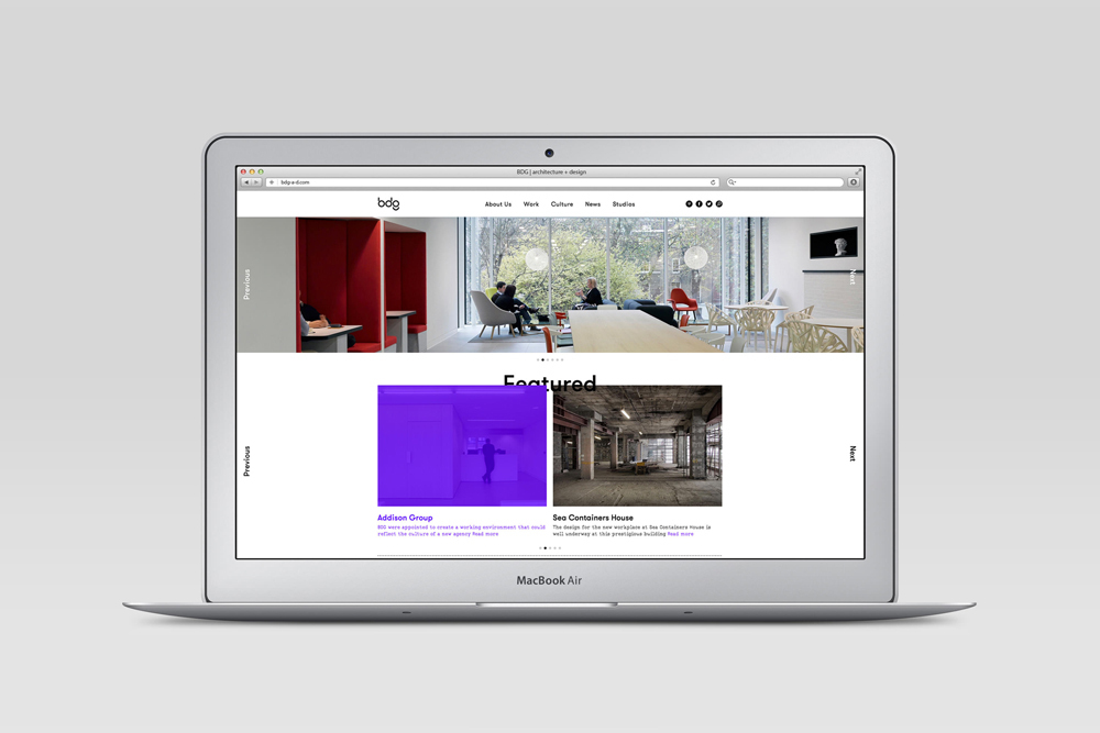 Mockup of an open MacBook Air displaying a website interface with architectural portfolio images.