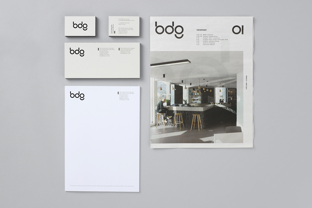 BDG brand identity layout showing business cards, letterhead, envelopes, and a brochure on a light grey background.