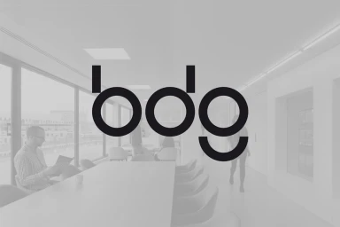 BDG brand identity logo overlaid on a monochromatic office conference room interior with seated people