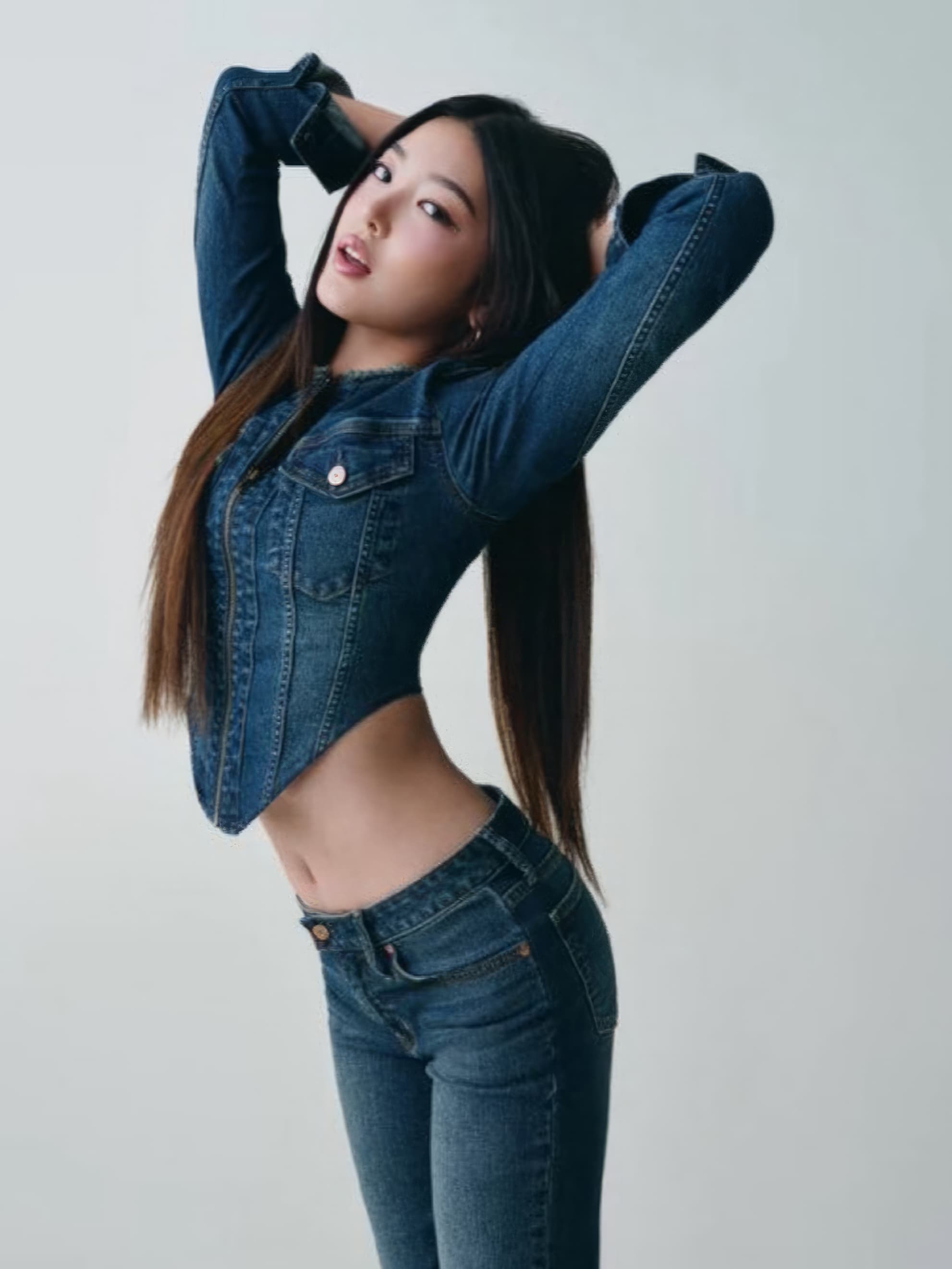 Woman posing in a fitted blue denim jacket and jeans against a plain white background for Gap Fall 2025 campaign.
