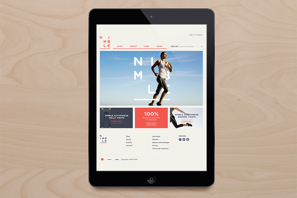 Digital tablet displaying Nimble e-commerce website on a wooden surface