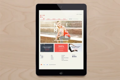 A tablet device displaying the Nimble activewear website on a light wood grain surface.