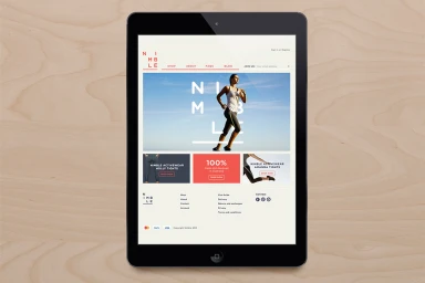 Digital tablet displaying Nimble e-commerce website on a wooden surface